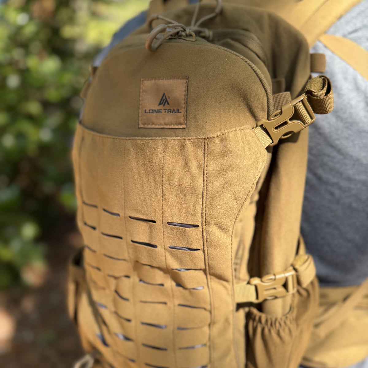 Close-up of the SB1 25L backpack's laser-cut MOLLE front panel and Lone Trail patch